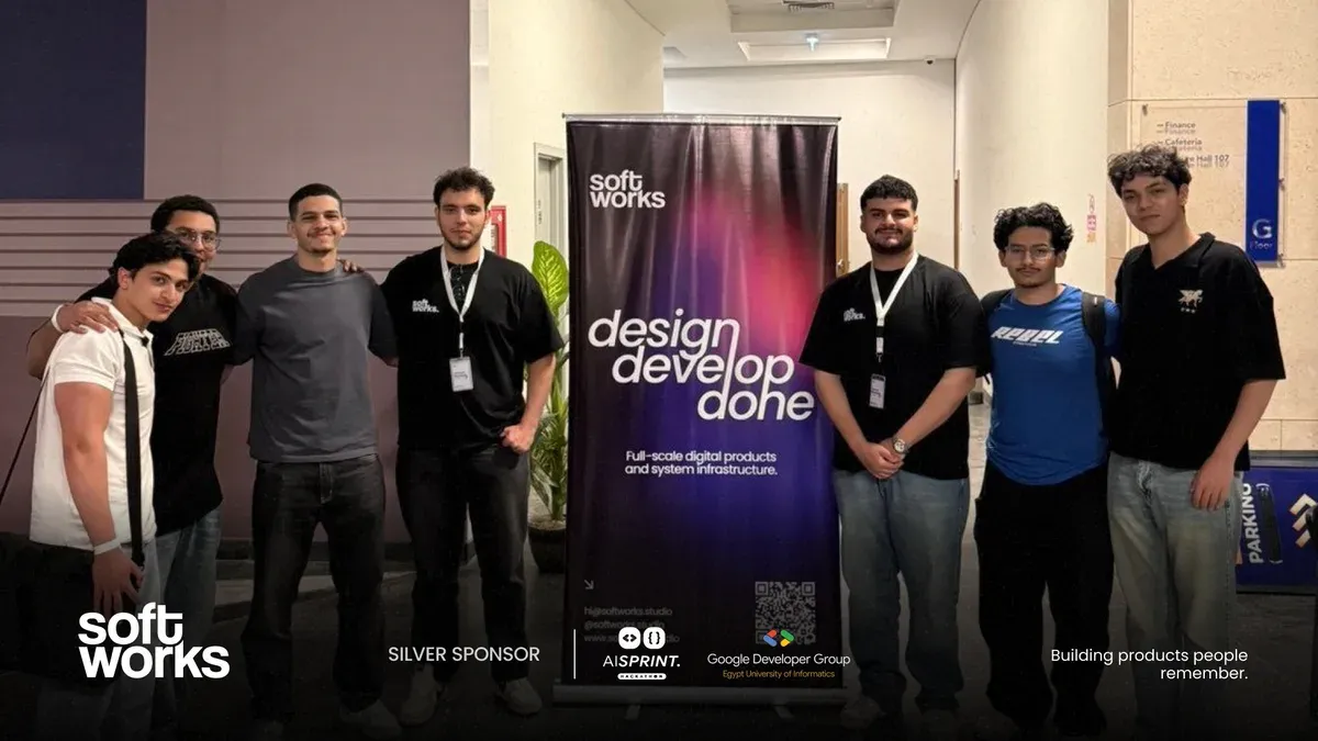 Softworks team with students beside the studio banner at AI Sprint.