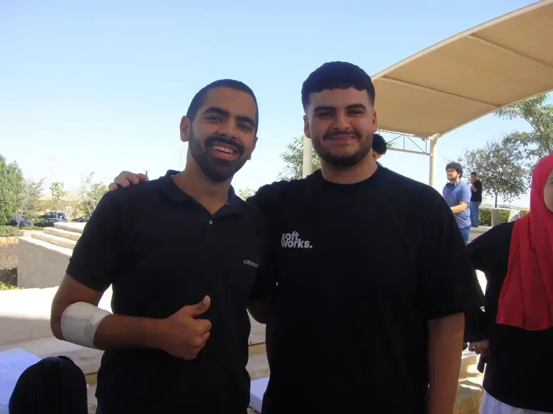 A Softworks team member with a fellow attendee on campus at EUI.